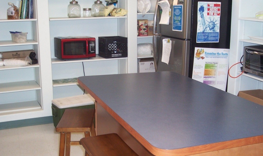 A kitchen with a counter and a microwave on it.